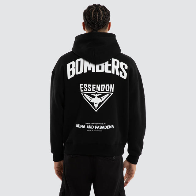 Model wears Essendon Bombers AFL Champions Box Hoodie Jet Black Hoodies in Black - Image 1