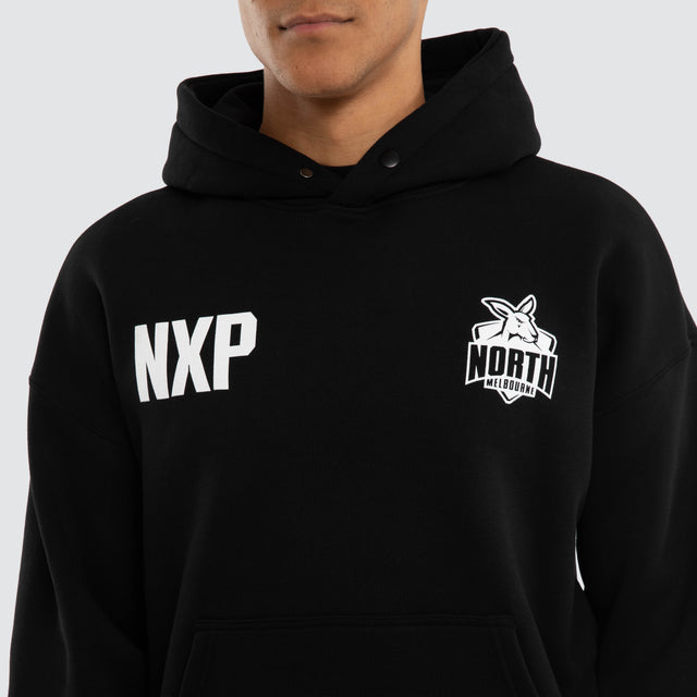 Model wears North Melbourne Kangaroos Champions Box Fit Hoodie Jet Black Hoodies in Black - Image 3
