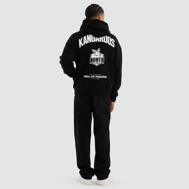 Model wears North Melbourne Kangaroos Champions Box Fit Hoodie Jet Black Hoodies in Black - Image 4