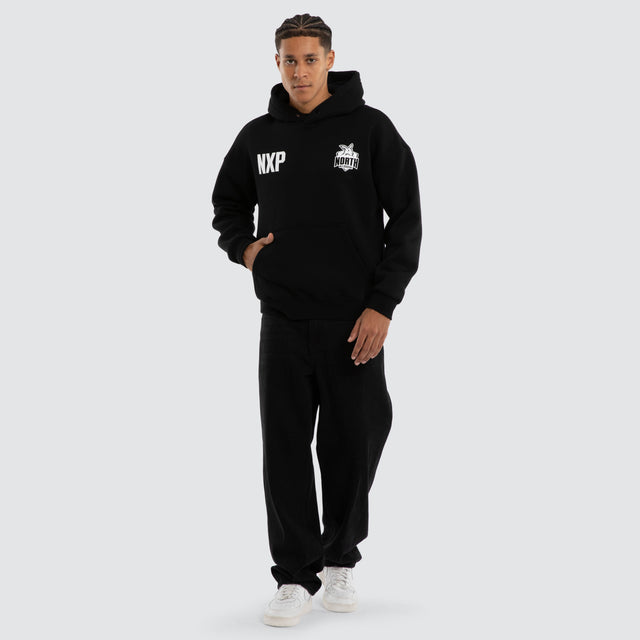 Model wears North Melbourne Kangaroos Champions Box Fit Hoodie Jet Black Hoodies in Black - Image 5