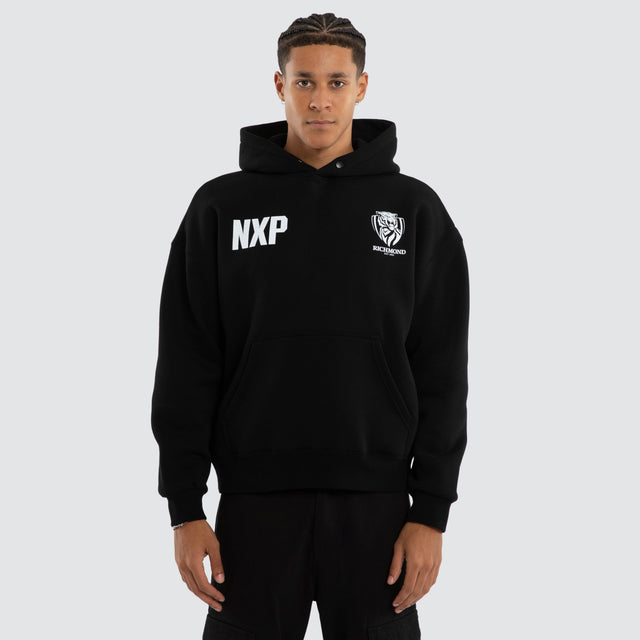 Model wears Richmond Tigers AFL Champions Box Hoodie Jet Black Hoodies in Black - Image 1