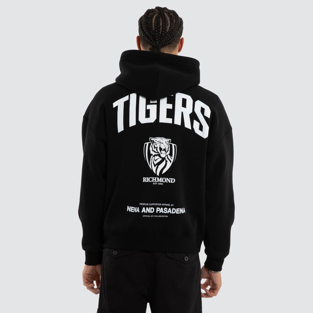 Model wears Richmond Tigers AFL Champions Box Hoodie Jet Black Hoodies in Black - Image 2