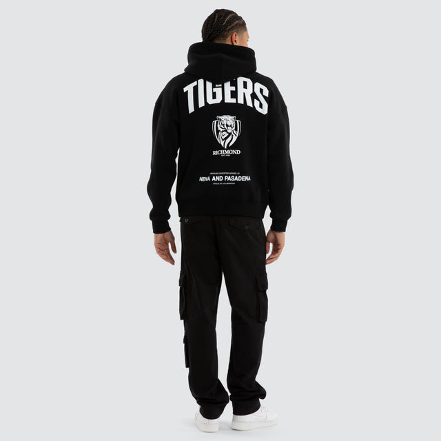 Model wears Richmond Tigers AFL Champions Box Hoodie Jet Black Hoodies in Black - Image 4