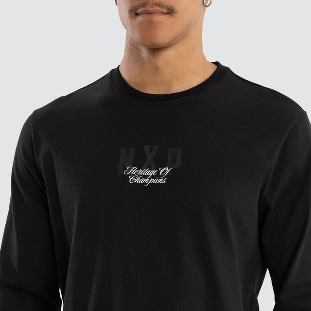 Model wears Final Dual Curved Longsleeve Tee Jet Black Longsleeve T-Shirts in Black - Image 6