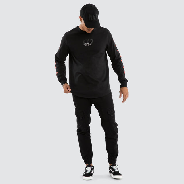 Model wears Final Dual Curved Longsleeve Tee Jet Black Longsleeve T-Shirts in Black - Image 5