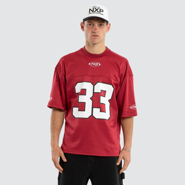 Model wears Offbeat Football Jersey Maroon Jersey in Red - Image 1