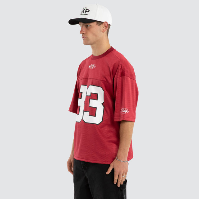 Model wears Offbeat Football Jersey Maroon Jersey in Red - Image 7