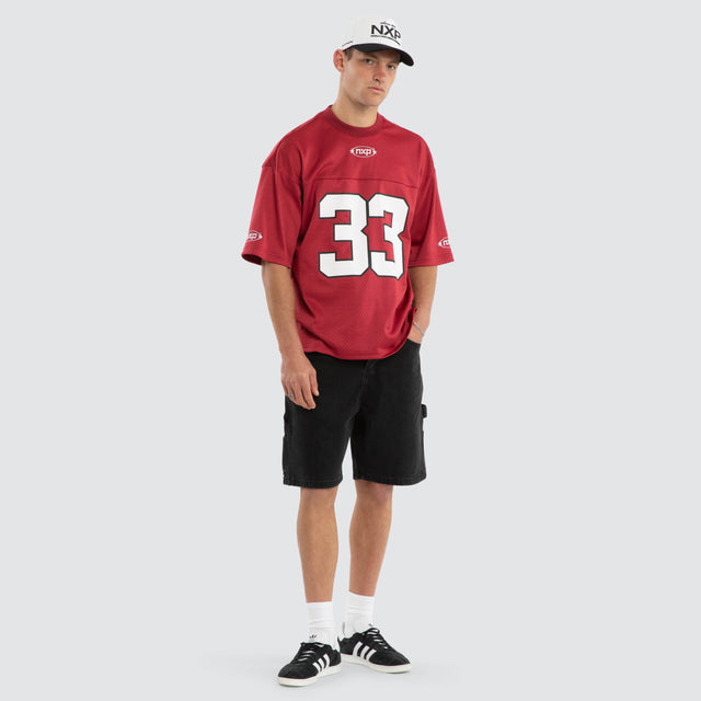 Model wears Offbeat Football Jersey Maroon Jersey in Red - Image 6