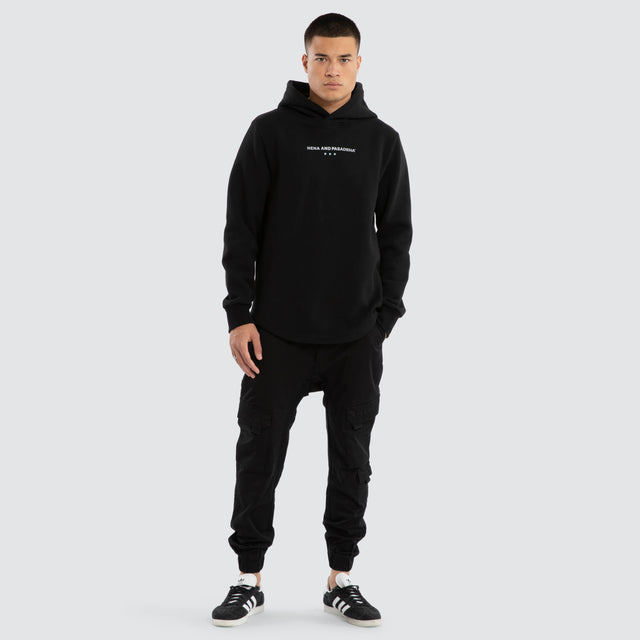 Model wears Unleash Curved Hem Hoodie Jet Black Hoodies in Black - Image 5