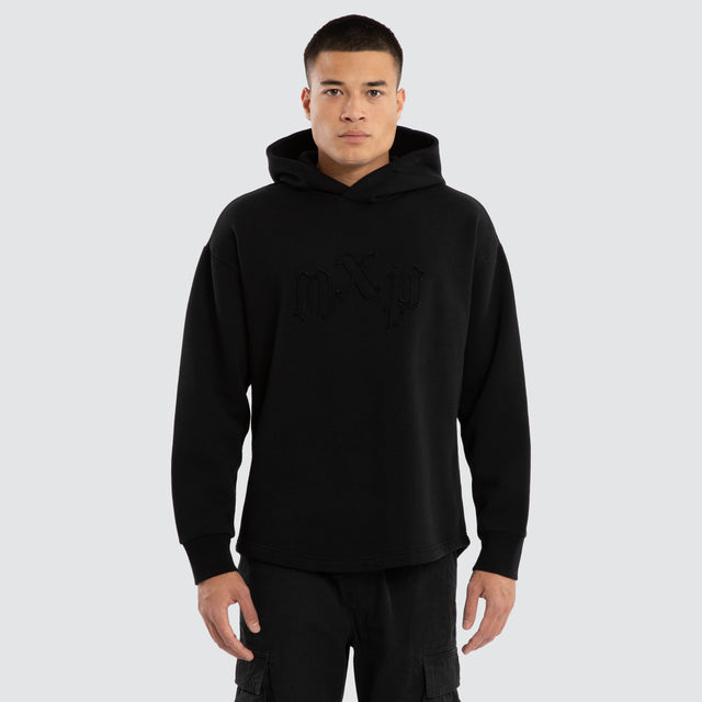 Model wears Supreme Relaxed Curved Hoodie Jet Black Hoodies in Black - Image 1