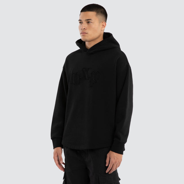Model wears Supreme Relaxed Curved Hoodie Jet Black Hoodies in Black - Image 3