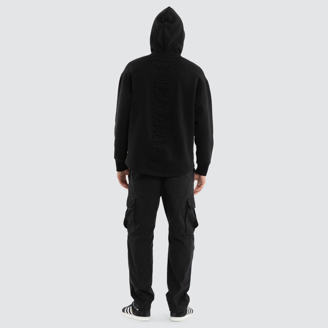 Model wears Supreme Relaxed Curved Hoodie Jet Black Hoodies in Black - Image 2