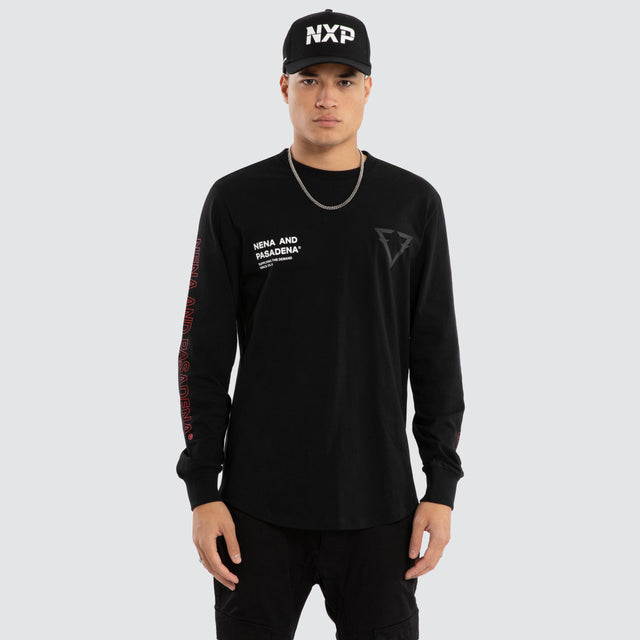 Model wears Unite Curved Hem Longsleeve Tee Jet Black Longsleeve T-Shirts in Black - Image 1