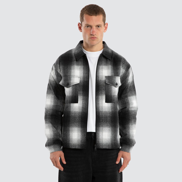 Model wears Rise Relaxed Jacket Black/White Check Jacket in Black - Image 1