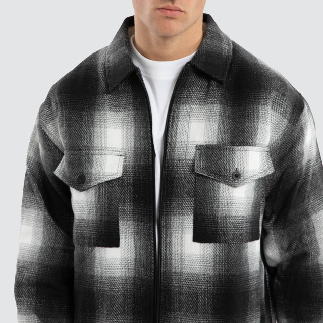Model wears Rise Relaxed Jacket Black/White Check Jacket in Black - Image 2