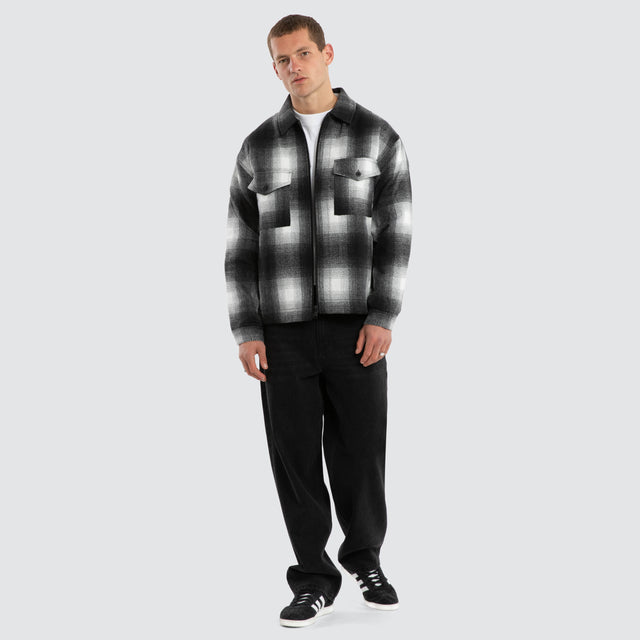 Model wears Rise Relaxed Jacket Black/White Check Jacket in Black - Image 5