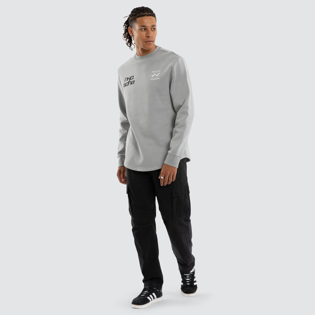 Model wears Independent Curved Sweater Pigment Ultimate Grey Jumpers in Grey - Image 5