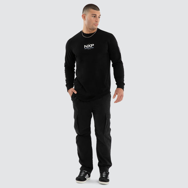 Model wears Peak Curved Hem Longsleeve Tee Black Longsleeve T-Shirts in Black - Image 5