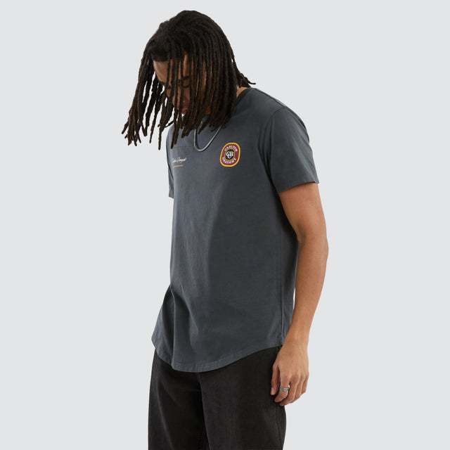 Model wears Carlton Draught General Dual Curved Tee Pigment Asphalt T-Shirts in Grey - Image 4