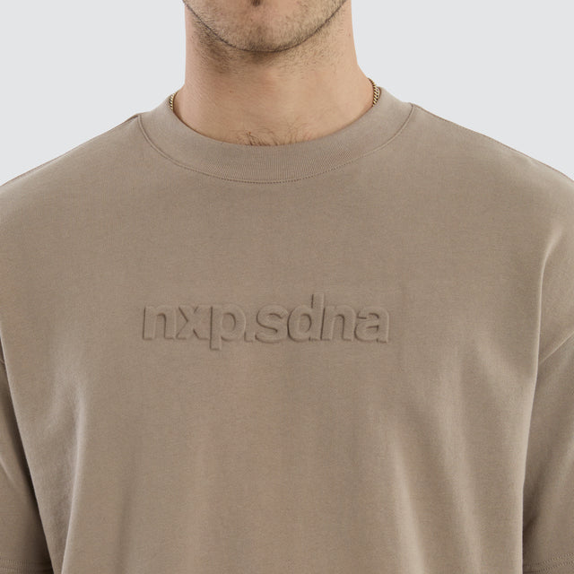 Model wears Overcome Raptor Tee Cinder T-shirt in brown - Image 3