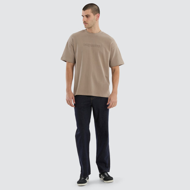 Model wears Overcome Raptor Tee Cinder T-shirt in brown - Image 5