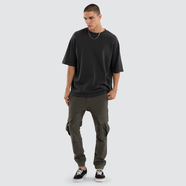 Model wears F150 Slim Nylon Cargo Jogger Dark Olive Pants in Green - Image 5