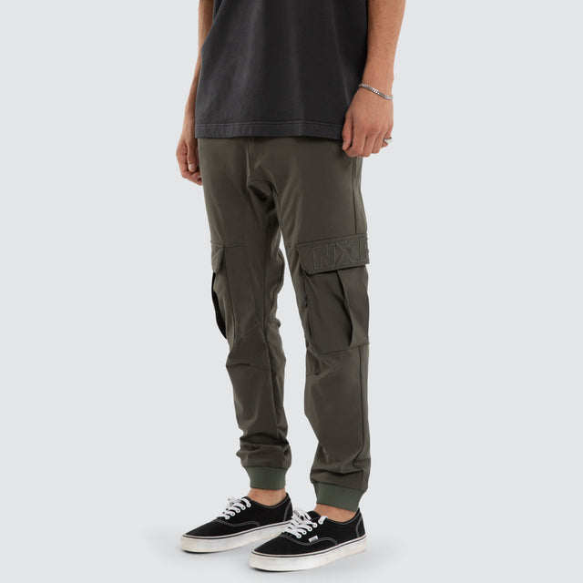 Model wears F150 Slim Nylon Cargo Jogger Dark Olive Pants in Green - Image 1
