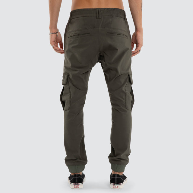 Model wears F150 Slim Nylon Cargo Jogger Dark Olive Pants in Green - Image 2