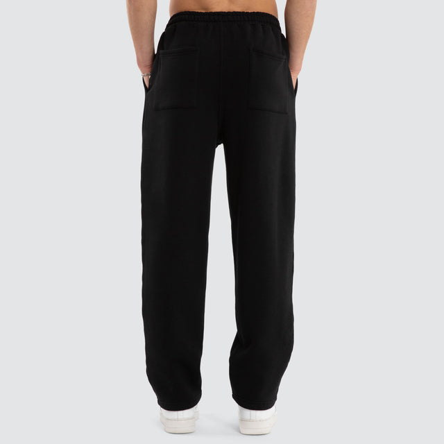 Model wears Realign Trackpant Jet Black Trackpants in Black - Image 3