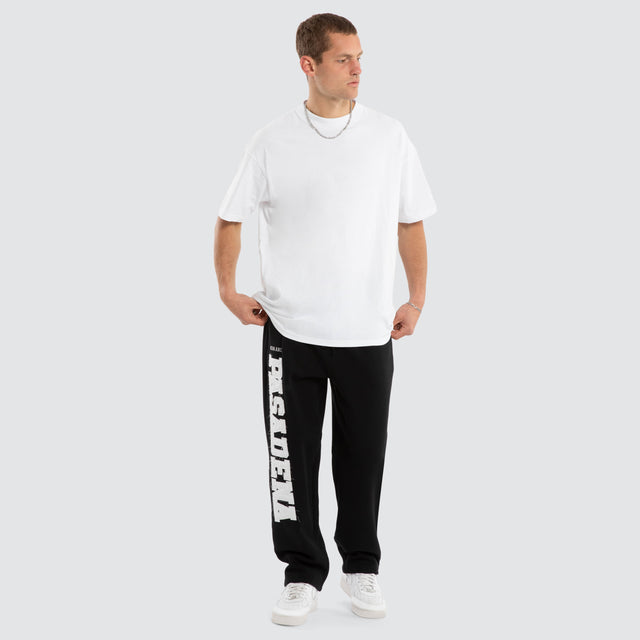 Model wears Realign Trackpant Jet Black Trackpants in Black - Image 4