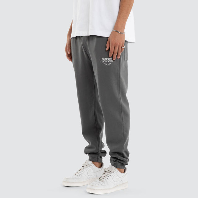 Model wears Capsule Trackpant Charcoal Trackpants in Grey - Image 1