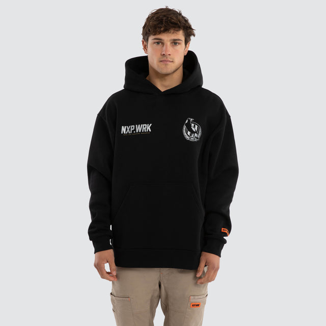 Model wears Collingwood Magpies Subject Hoodie Jet Black Hoodies in Black - Image 1