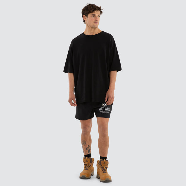 Model wears Collingwood Magpies Contract Short Jet Black Shorts in Black - Image 5