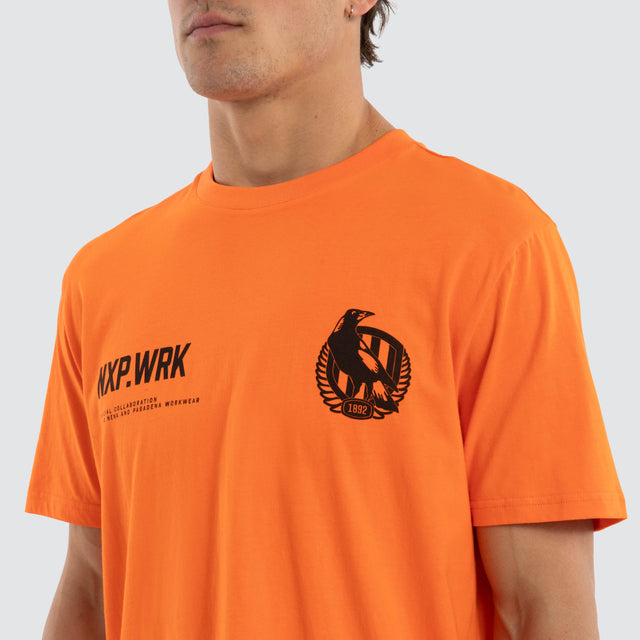 Model wears Collingwood Magpies Ethic Tee Work Orange T-Shirts in Orange - Image 4