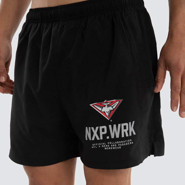 Model wears Essendon Bombers Contract Short Jet Black Shorts in Black - Image 3