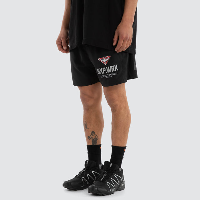 Model wears Essendon Bombers Contract Short Jet Black Shorts in Black - Image 5