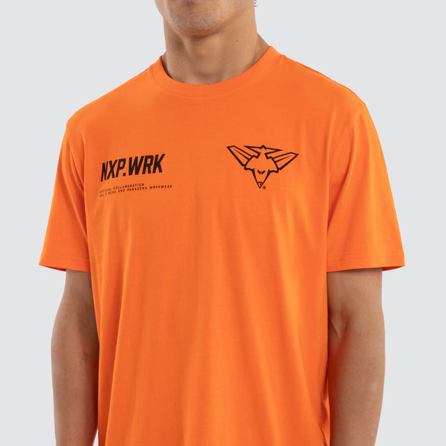 Model wears Essendon Bombers Ethic Tee Work Orange T-Shirts in Orange - Image 4