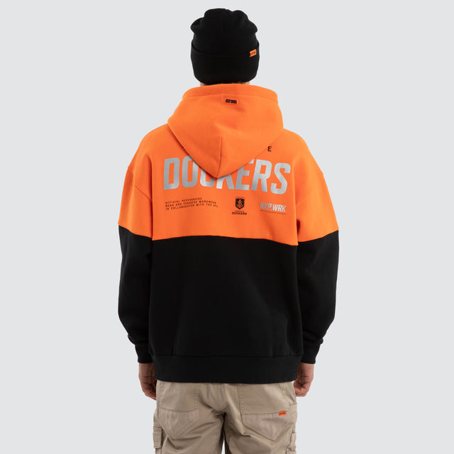 Model wears Fremantle Dockers Block Hoodie Orange Black Hoodies in Orange - Image 2
