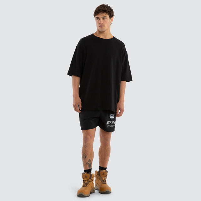 Model wears Geelong Cats Contract Short Jet Black Shorts in Black - Image 4