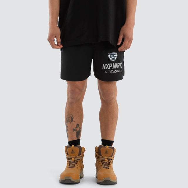 Model wears Geelong Cats Contract Short Jet Black Shorts in Black - Image 1