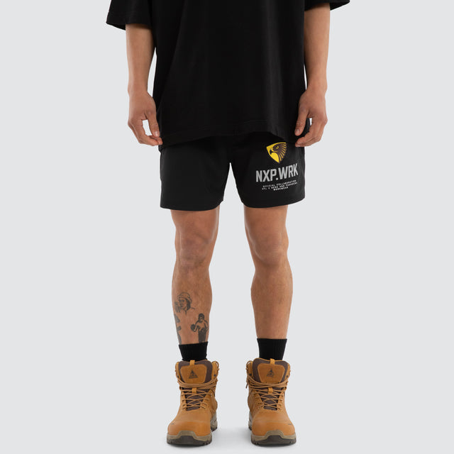 Model wears Hawthorn Hawks Contract Short Jet Black Shorts in Black - Image 1
