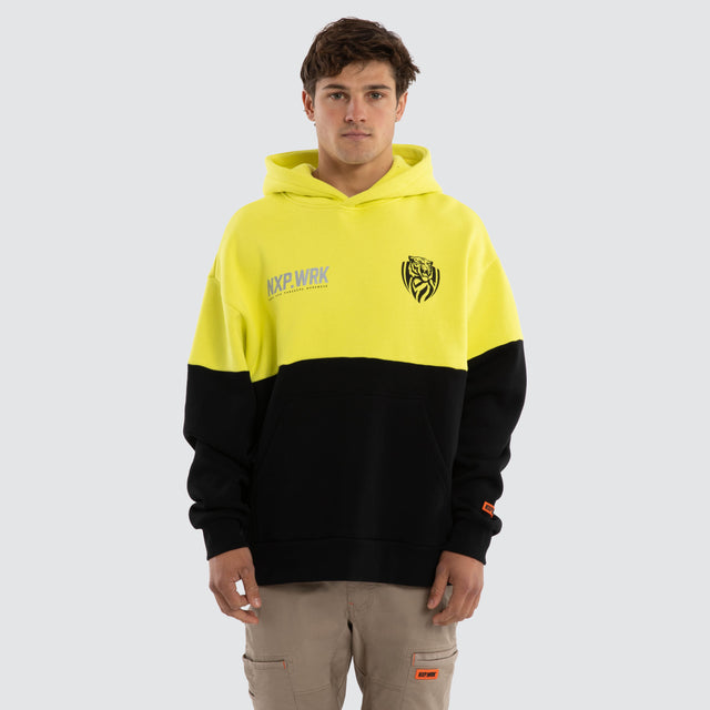 Model wears Richmond Tigers Block Hoodie Yellow Black Hoodies in Yellow - Image 1