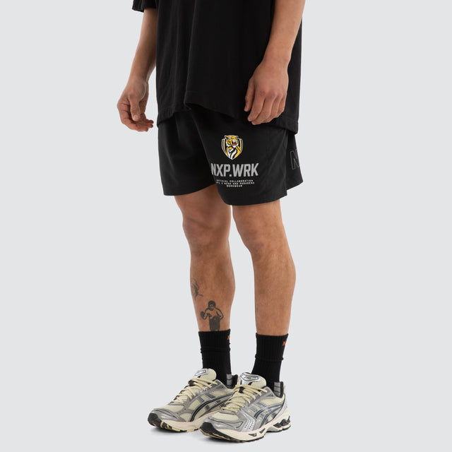 Model wears Richmond Tigers Contract Short Jet Black Shorts in Black - Image 4