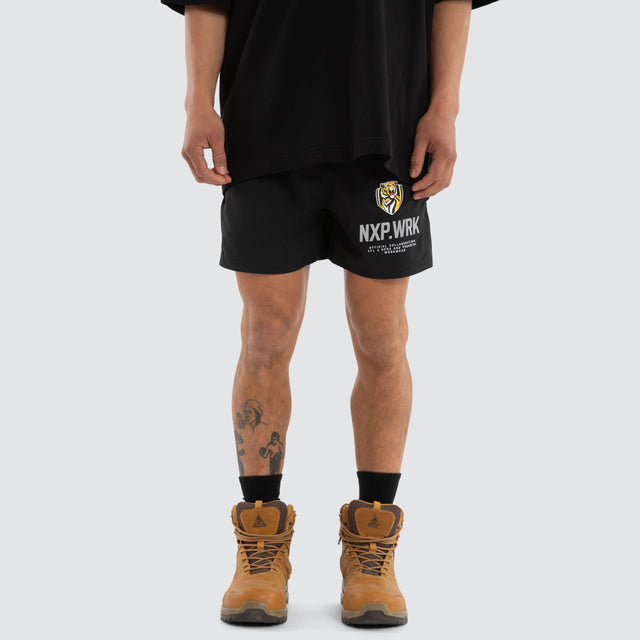 Model wears Richmond Tigers Contract Short Jet Black Shorts in Black - Image 1